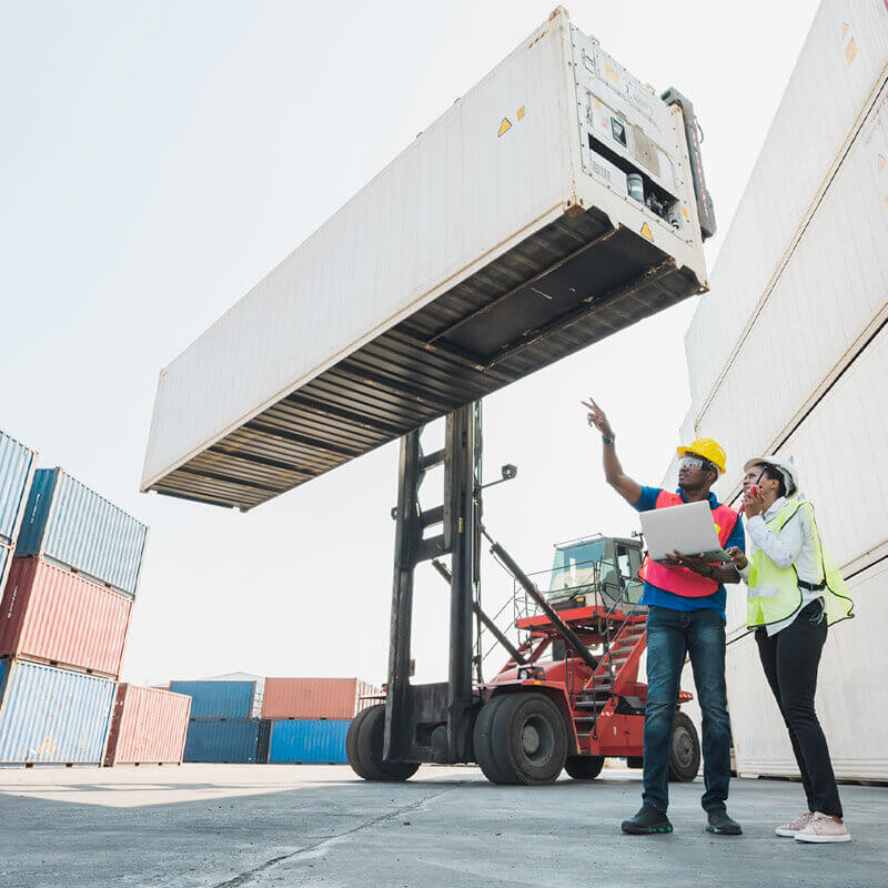 Workers conversing near containers