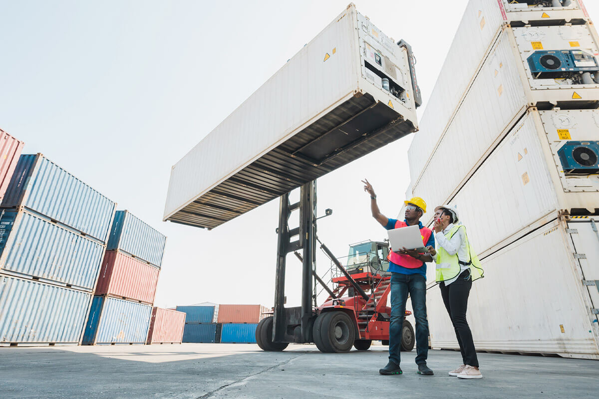 Workers conversing near containers